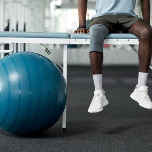 Paciente en rehabilitación intensiva haciendo ejercicios con una pelota.